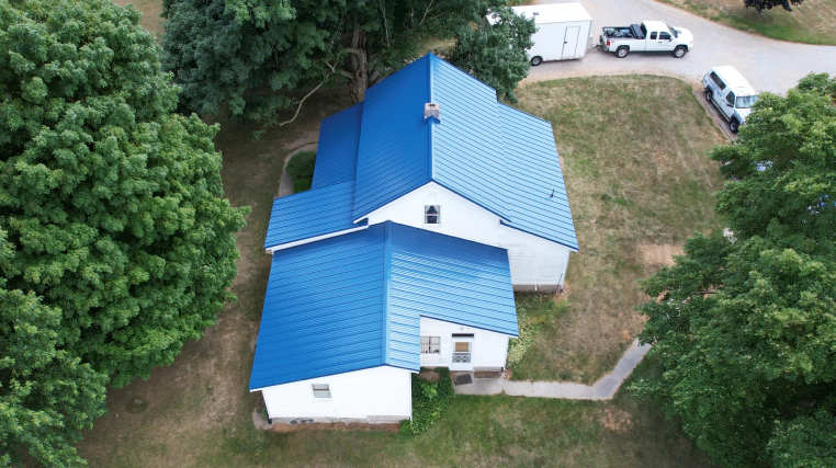 two story house with blue metal roofing bourbon in