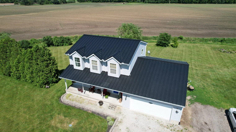 two story house with dark blue metal roof bourbon in
